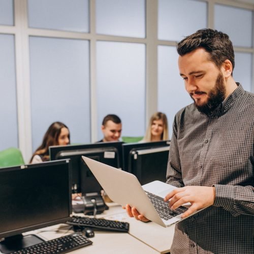 Workers at an IT company working on a computer